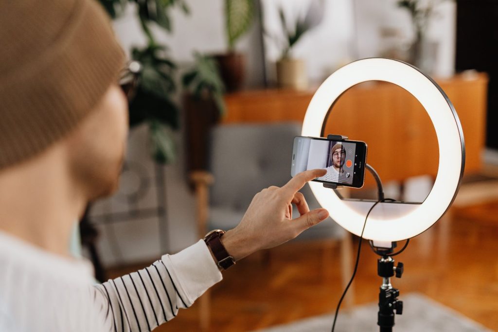 man taking photo of himself with ring light as a marketing expert